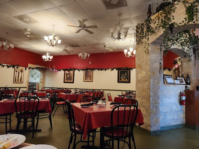 Italian Garden dining room with red tablecloths and chandeliers